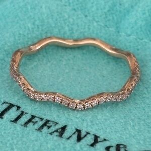 Rose gold band with pink diamonds. Size 7.